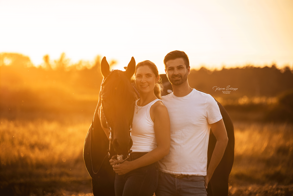Paar mit Pferd im Sonnenuntergang